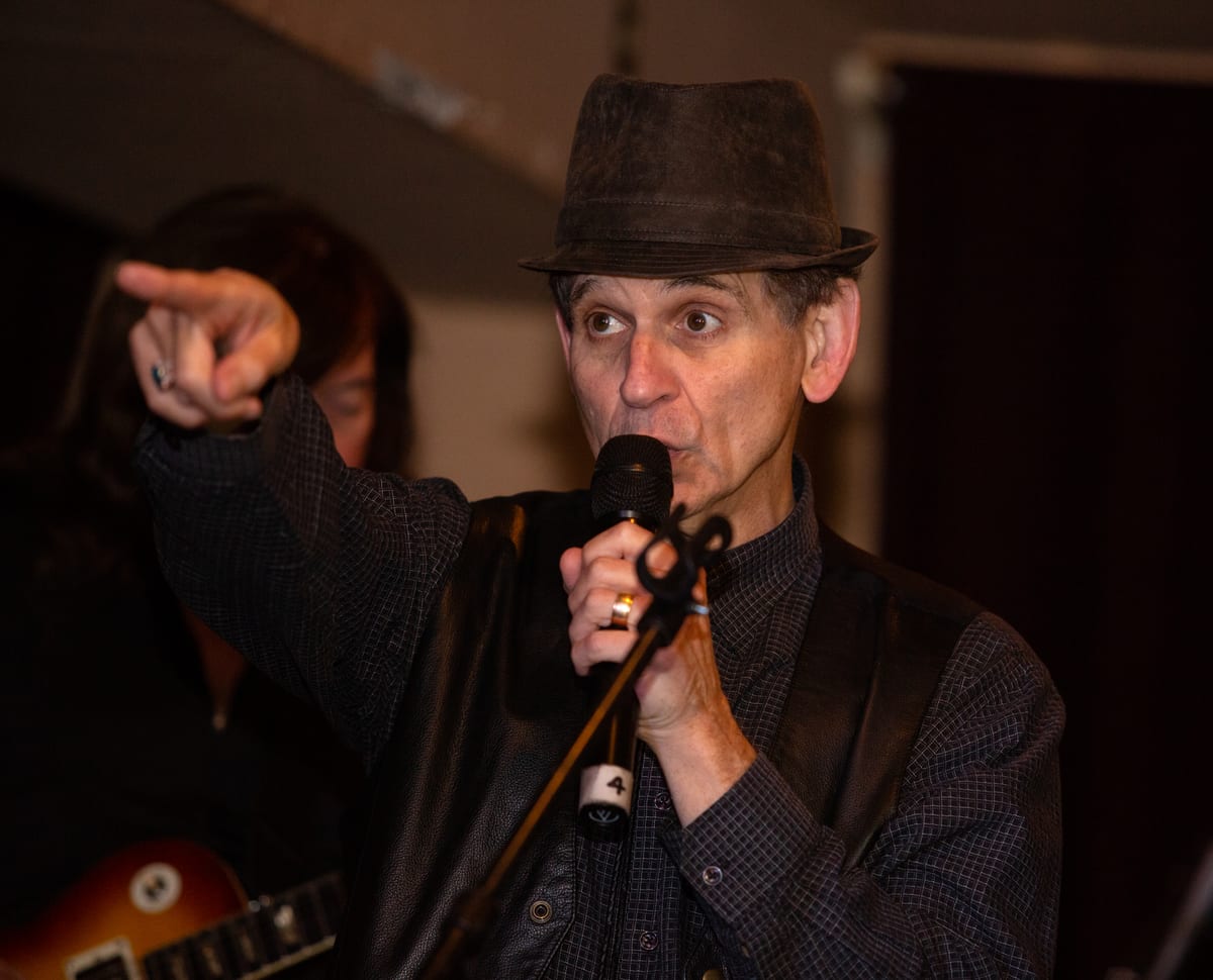Alan Sharavsky performing with a microphone